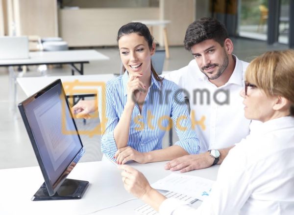 Shot of bank assistant businesswoman sitting at office desk with her clients and consulting.